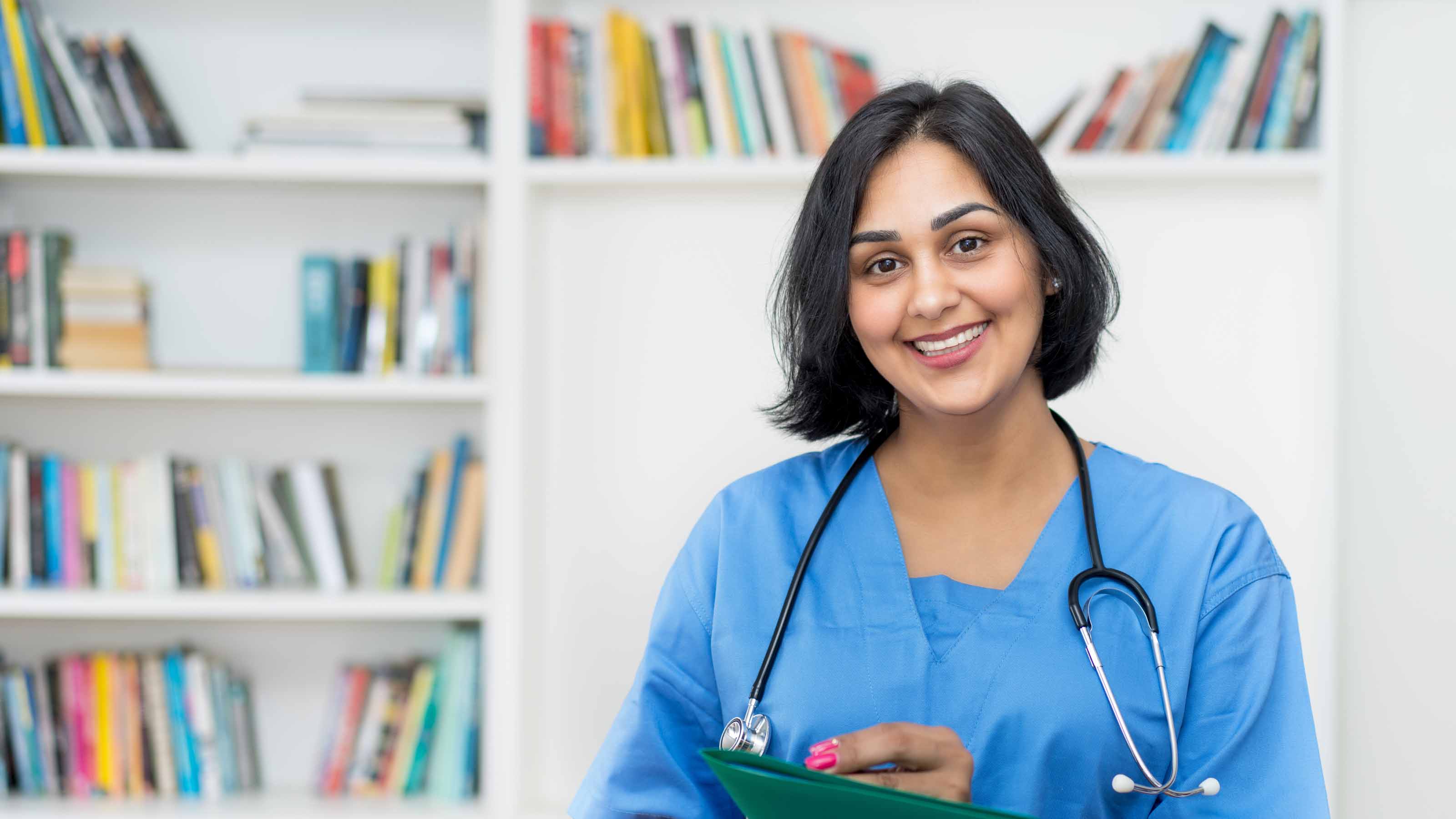 Smiling female nurse with file of patient