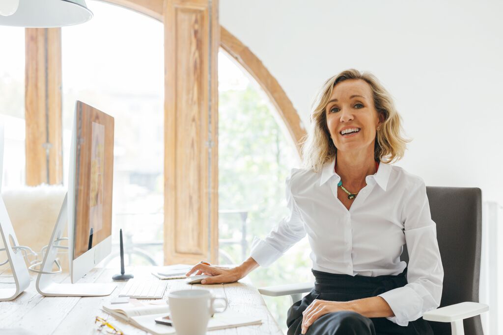 blonde haired woman sitting in home office