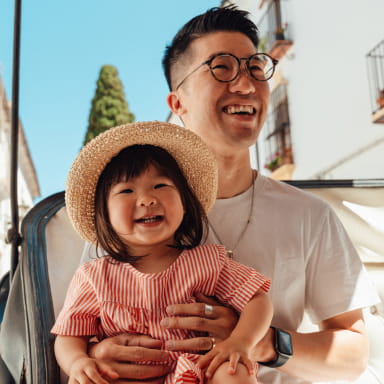 Man holding his daughter while laughing together
