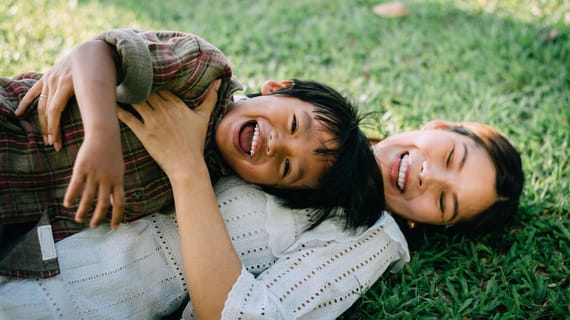 Laughing and playing on the grass