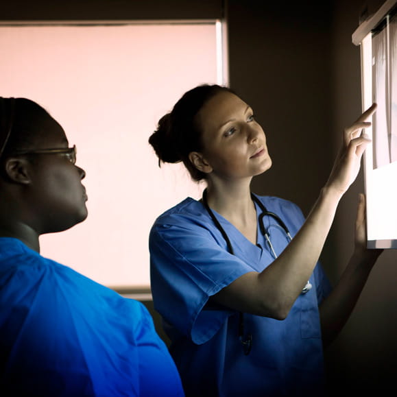 Two healthcare professionals reviewing a radiograph
