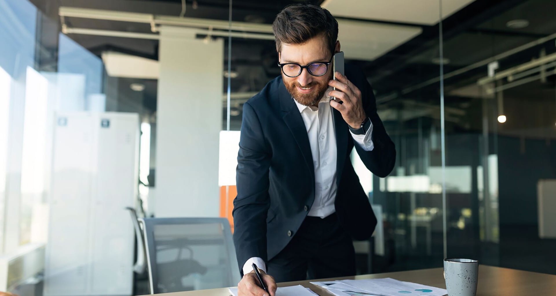 Man in an office meeting room talking on phone