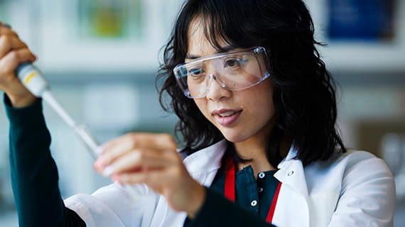 Woman in a laboratory mixing test samples