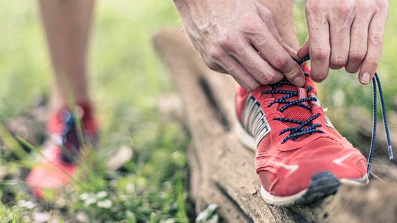 Trainer shoelaces being tied up