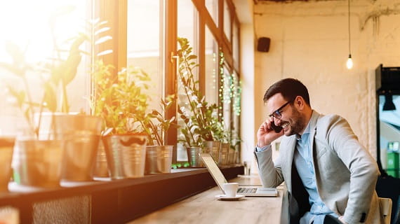man on telephone at coffee bar