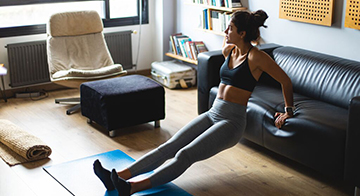 Woman exercises in her living room
