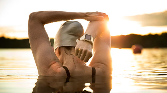 Outdoor swimmer stretching.