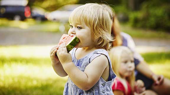 Little girl eating watermelon