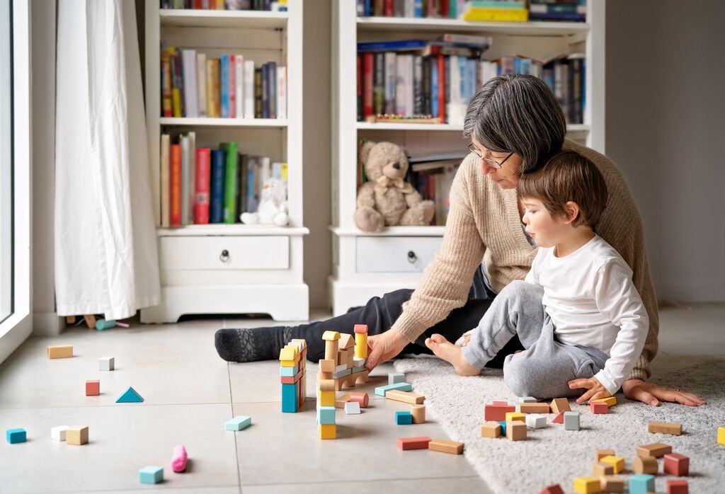 lady and young child playing with building blocks