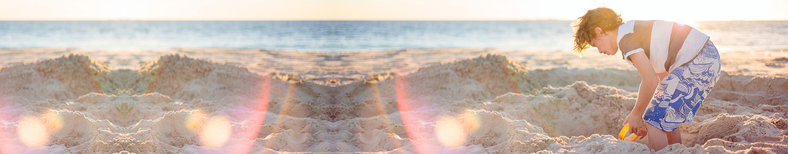 Child on a beach playing in the sand Parenting banner