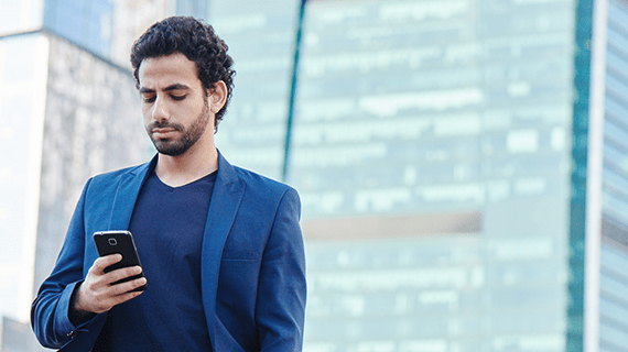 Man looking down at his mobile phone.