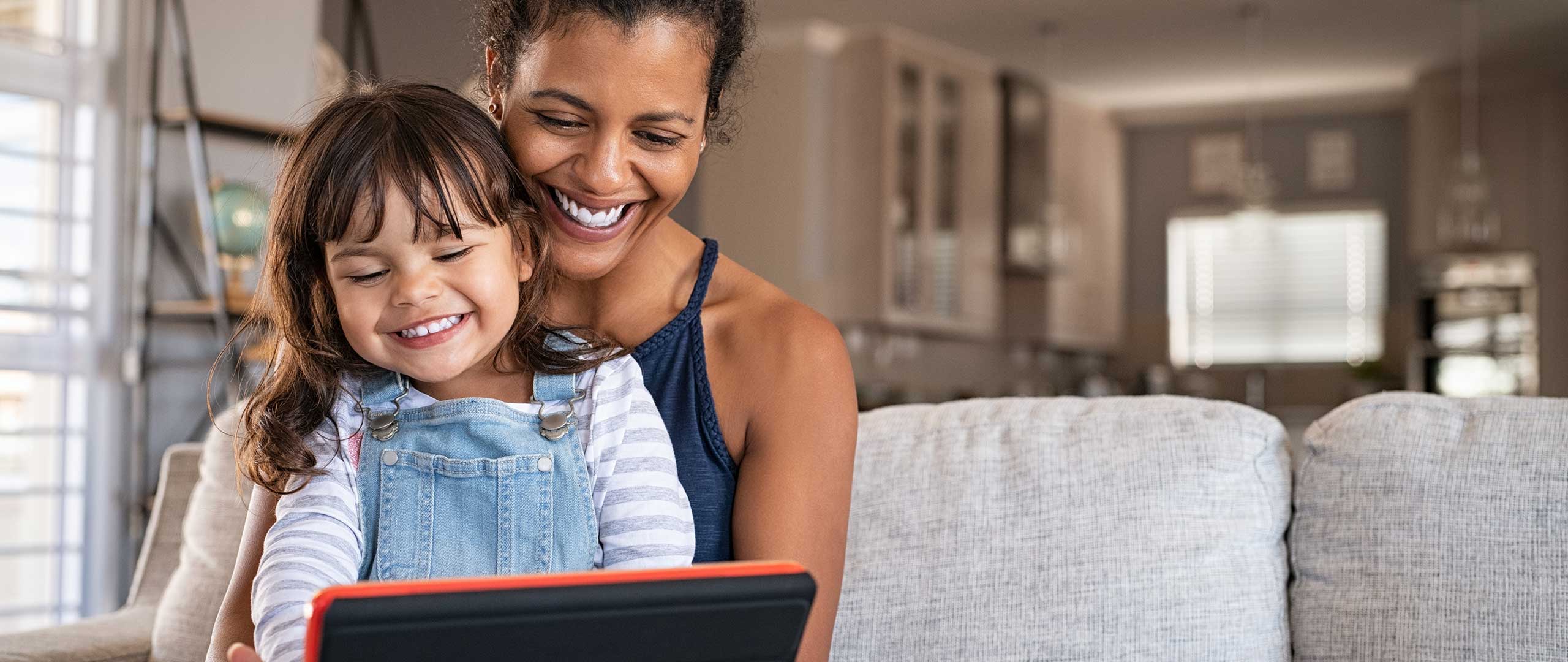 Woman and child sitting with a tablet device