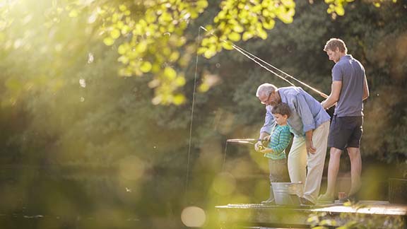 Older man, man and boy fishing