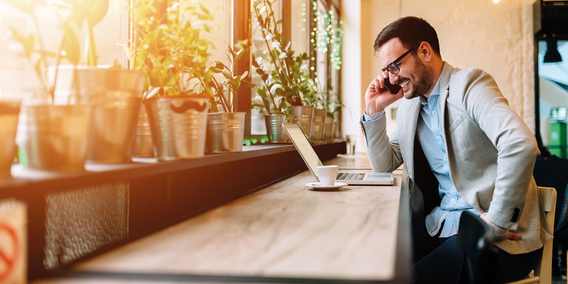Man sitting at a desk on the phone. Bupa Global launched its second Executive Wellbeing Index on 20 September 2021