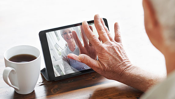 A woman using a tablet. Apps and technologies can make a difference to those in their older years