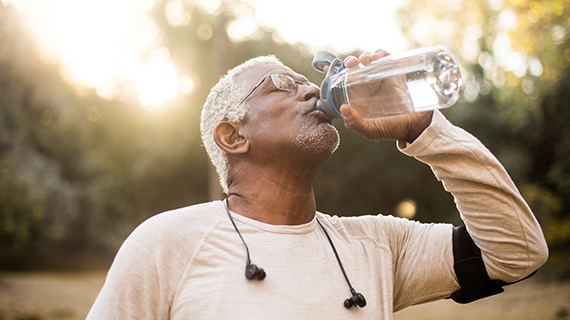 Man drinking from a bottle of water.