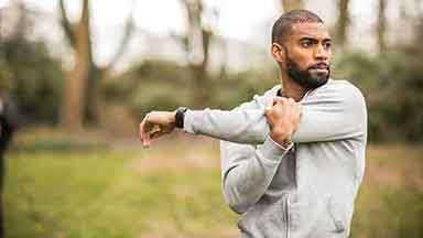 Man outside doing warm up exercise
