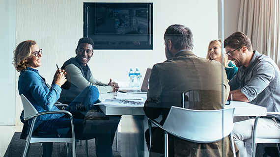 People sitting around a table in a meeting.
