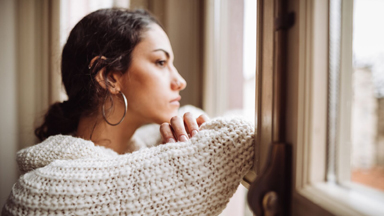 woman staring out of window