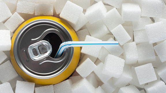 Drink can among sugar cubes